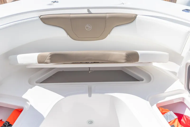  Yacht Photos Pics 2023 Edgewater 370CC boat interior with cushioned seating and storage compartment.