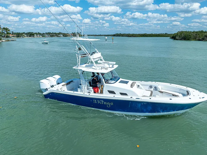  Yacht Photos Pics 2023 Edgewater 370CC boat cruising on a sunny day with clear skies.