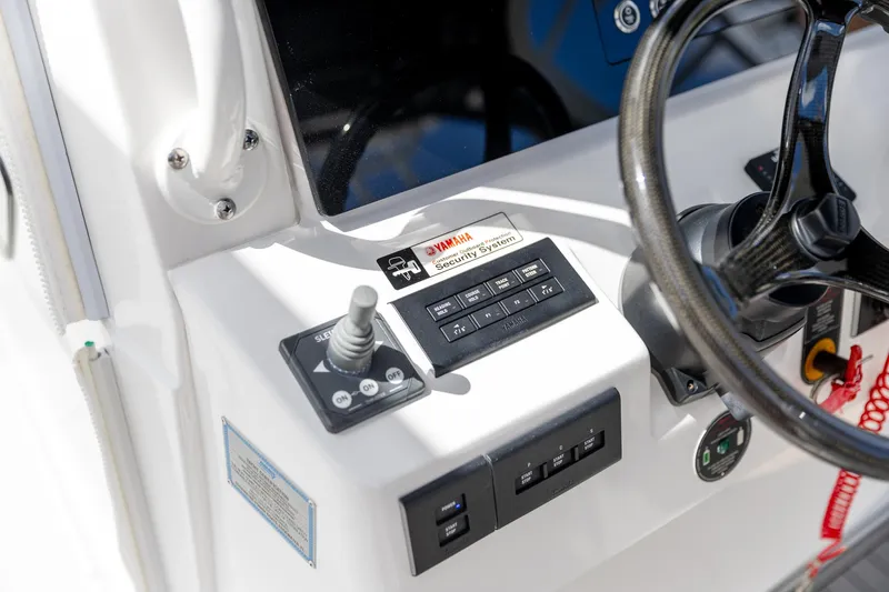  Yacht Photos Pics Control panel of 2023 Edgewater 370CC boat with steering wheel and joystick.