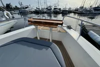 Bow view of 2023 Nimbus C11 yacht docked at marina with wooden table.
