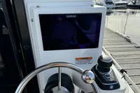 Steering wheel and control panel of 2023 Nimbus C11 boat at marina.