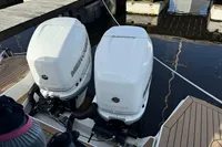 Twin Mercury outboard engines on a 2023 Nimbus C11 boat at a dock.