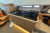 Modern kitchen area in 2023 Nimbus C11 boat with sink and stove.