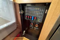 Control panel inside a 2023 Nimbus C11 boat, featuring switches and gauges.