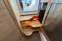 Compact wooden staircase in 2023 Nimbus C11 boat interior, featuring storage and modern design.