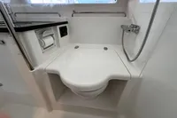 Modern bathroom in 2023 Nimbus C11 boat with compact toilet and shower.