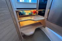 Wooden interior steps with ambient lighting in a 2023 Nimbus C11 boat.