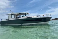 2023 Nimbus C11 boat on clear turquoise water under a blue sky.
