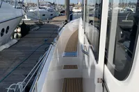 2023 Nimbus C11 boat docked at marina, showcasing sleek design and wooden deck.