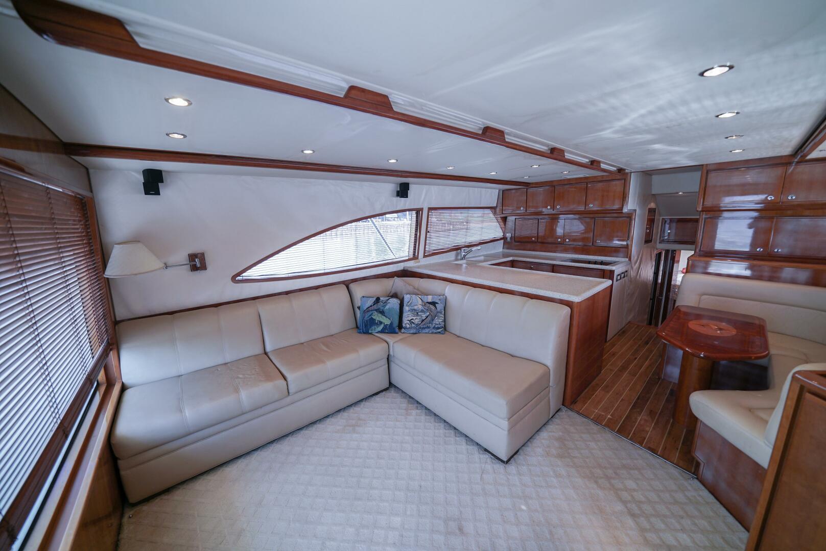Luxurious interior of a 2007 Bertram 510 Convertible yacht with plush seating and wood accents.