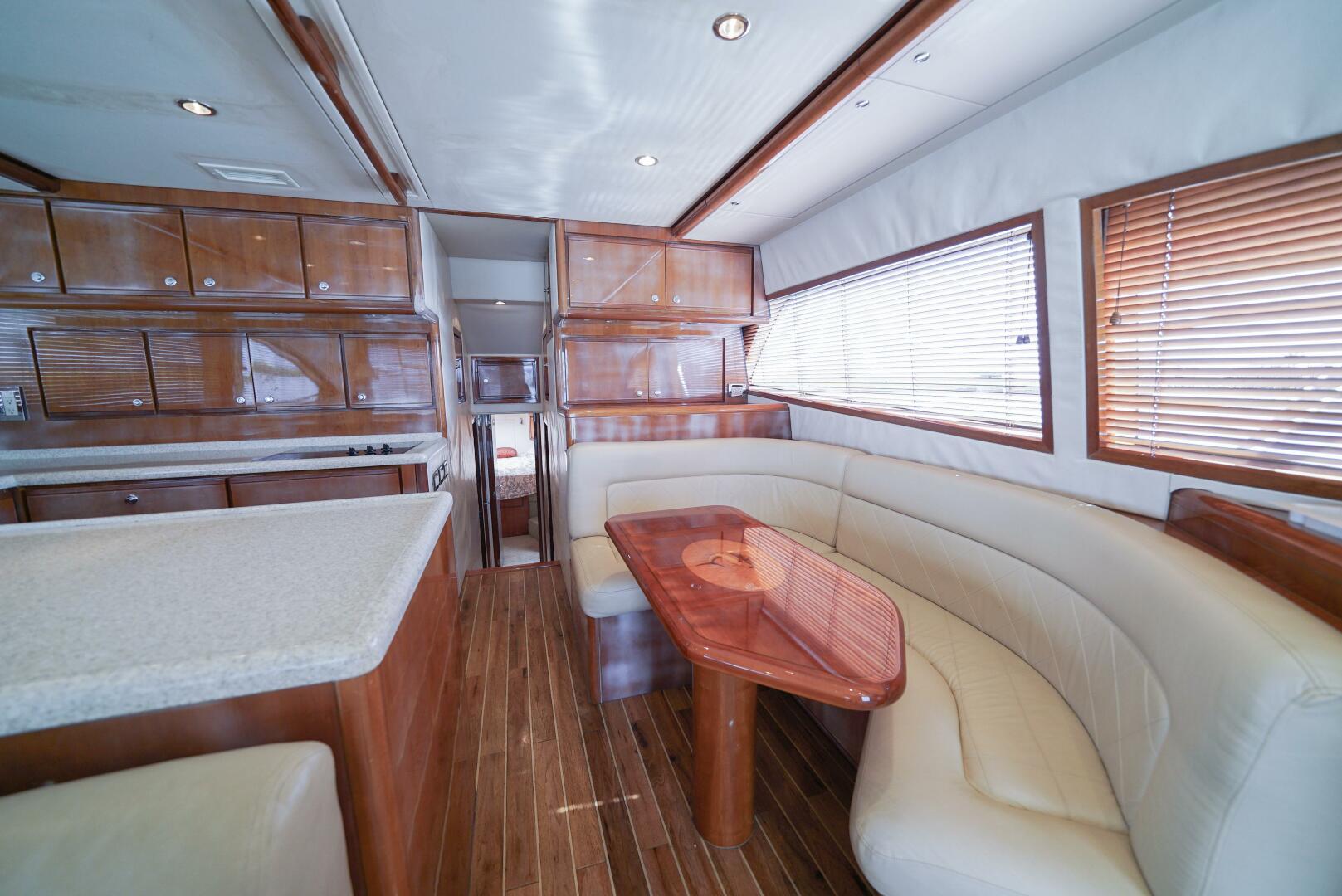 Luxurious interior of 2007 Bertram 510 Convertible yacht with wood finishes and plush seating.