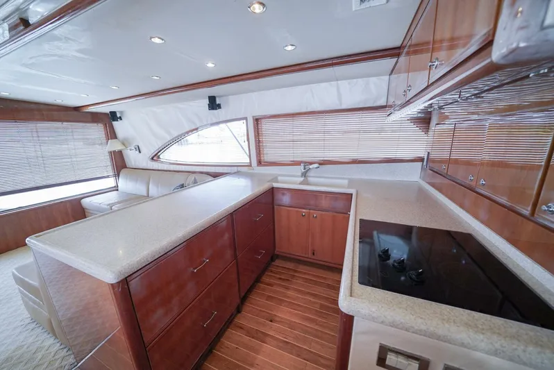 Smoker II Yacht Photos Pics Luxurious kitchen interior of 2007 Bertram 510 Convertible yacht with wood cabinetry and modern appliances.