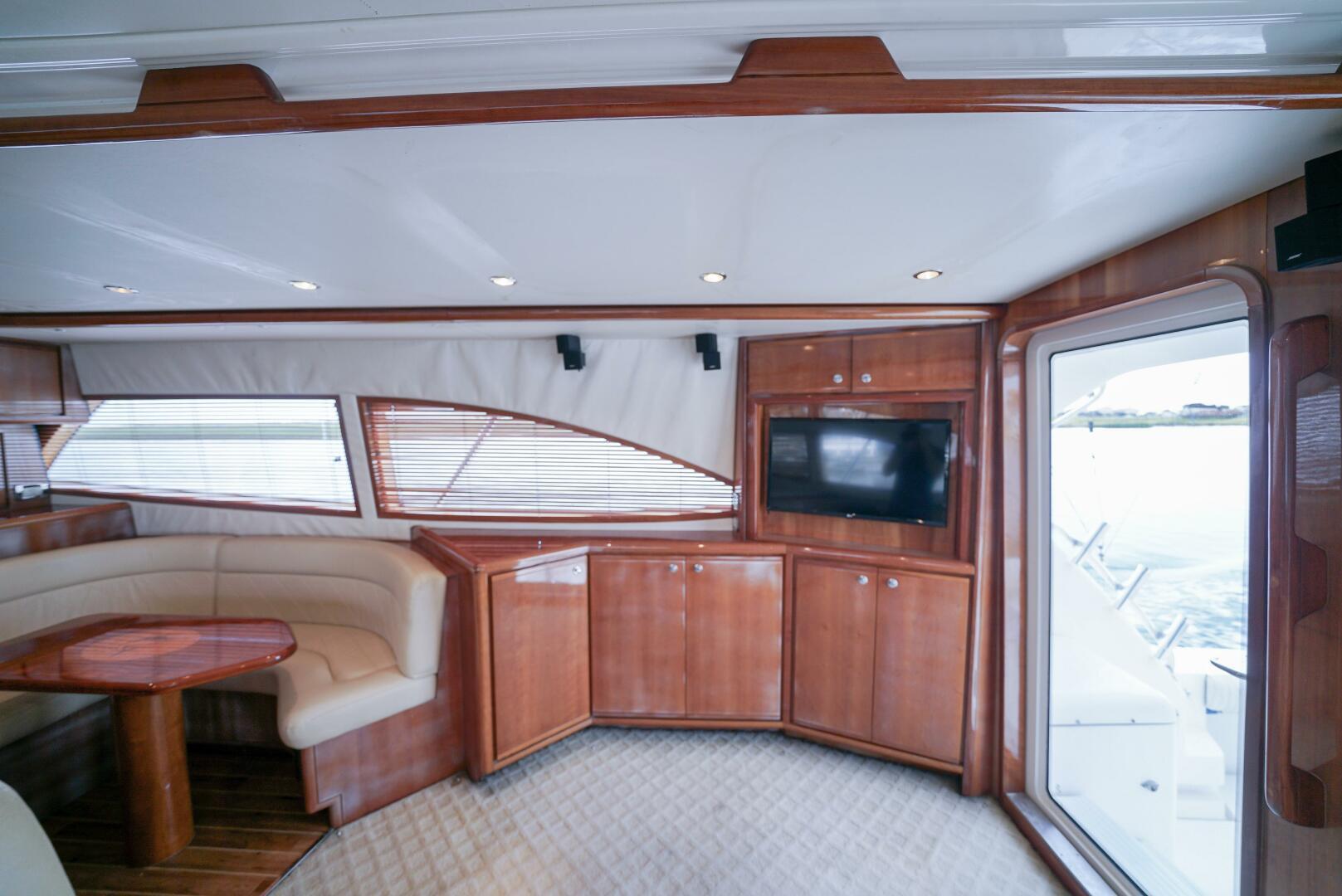 Interior of 2007 Bertram 510 Convertible yacht with wood cabinetry and seating area.