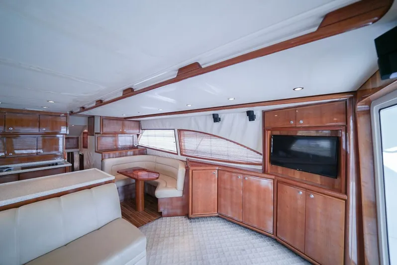 Smoker II Yacht Photos Pics Luxurious interior of a 2007 Bertram 510 Convertible yacht with wood finishes and seating area.