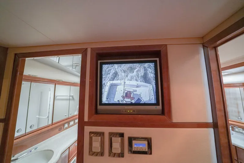 Smoker II Yacht Photos Pics Interior of 2007 Bertram 510 Convertible yacht with TV and bathroom view.