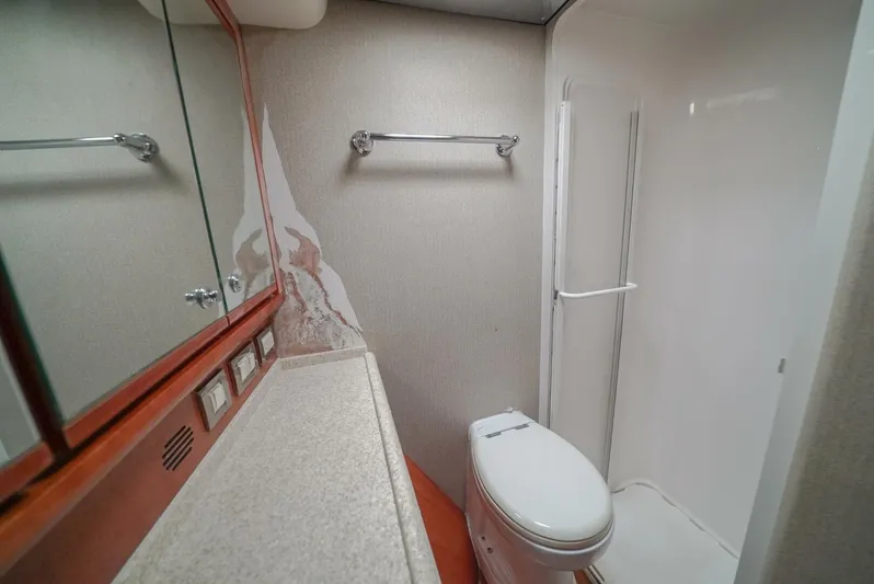 Smoker II Yacht Photos Pics Bathroom interior of 2007 Bertram 510 Convertible yacht, featuring shower and toilet.