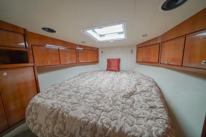 Smoker II Yacht Photos Pics Luxurious cabin interior of 2007 Bertram 510 Convertible with wood cabinets and skylight.