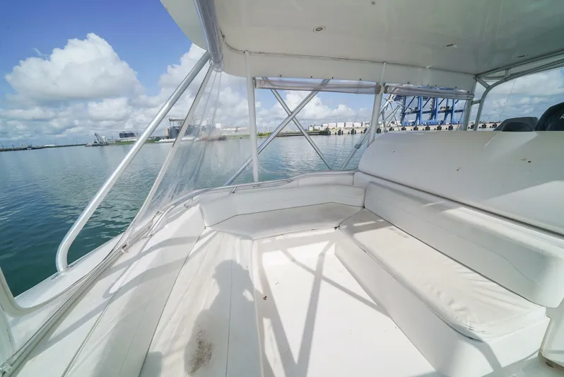 Smoker II Yacht Photos Pics 2007 Bertram 510 Convertible boat interior with white seating, overlooking calm waters.