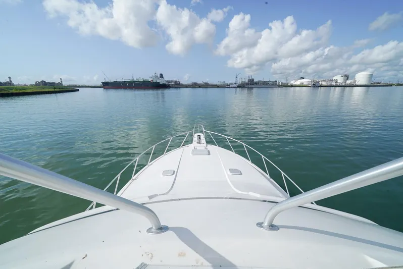 Smoker II Yacht Photos Pics Bow view of 2007 Bertram 510 Convertible on calm waters under a cloudy sky.