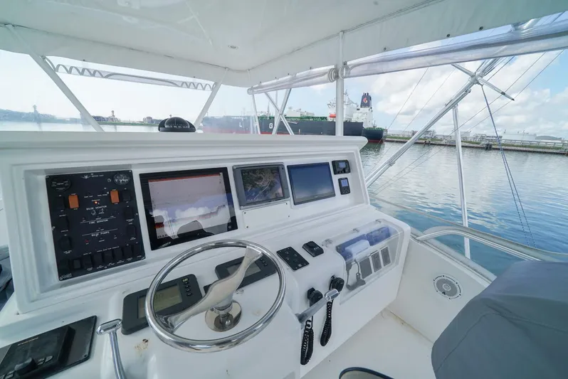 Smoker II Yacht Photos Pics 2007 Bertram 510 Convertible yacht helm with navigation screens and steering wheel.