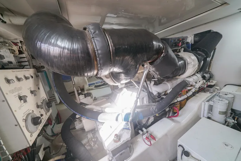 Smoker II Yacht Photos Pics Engine room of a 2007 Bertram 510 Convertible yacht, showcasing complex machinery and components.