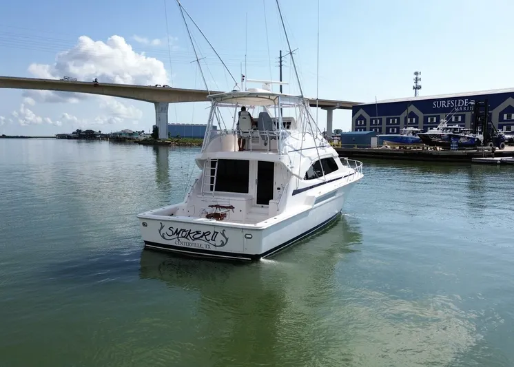 Smoker II Yacht Photos Pics 2007 Bertram 510 Convertible yacht docked near a bridge and marina.