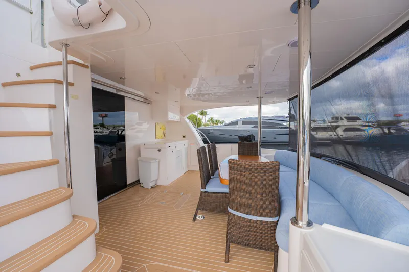 Mystic Soul Yacht Photos Pics Luxurious 2019 Horizon PC52 yacht interior with seating, table, and staircase.