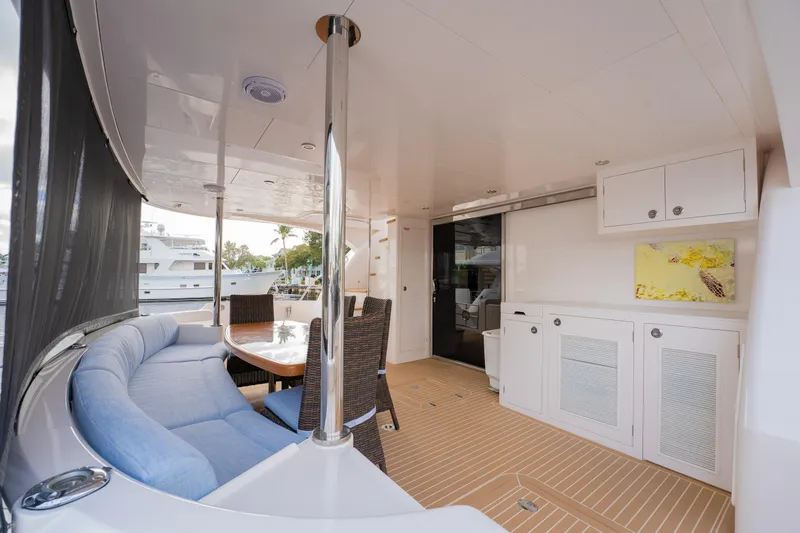 Mystic Soul Yacht Photos Pics Luxurious 2019 Horizon PC52 yacht interior with seating, table, and cabinetry.