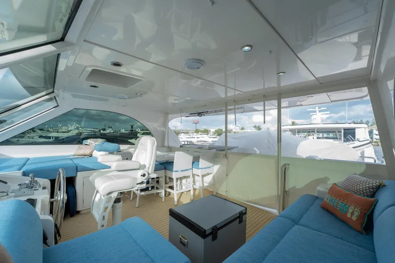 Mystic Soul Yacht Photos Pics Luxurious interior of 2019 Horizon PC52 yacht with blue seating and modern design.