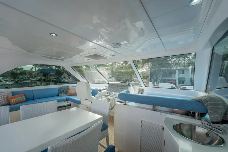 Mystic Soul Yacht Photos Pics Luxurious interior of 2019 Horizon PC52 yacht with modern seating and panoramic windows.