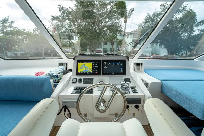 Mystic Soul Yacht Photos Pics Helm of 2019 Horizon PC52 yacht with navigation screens and steering wheel.