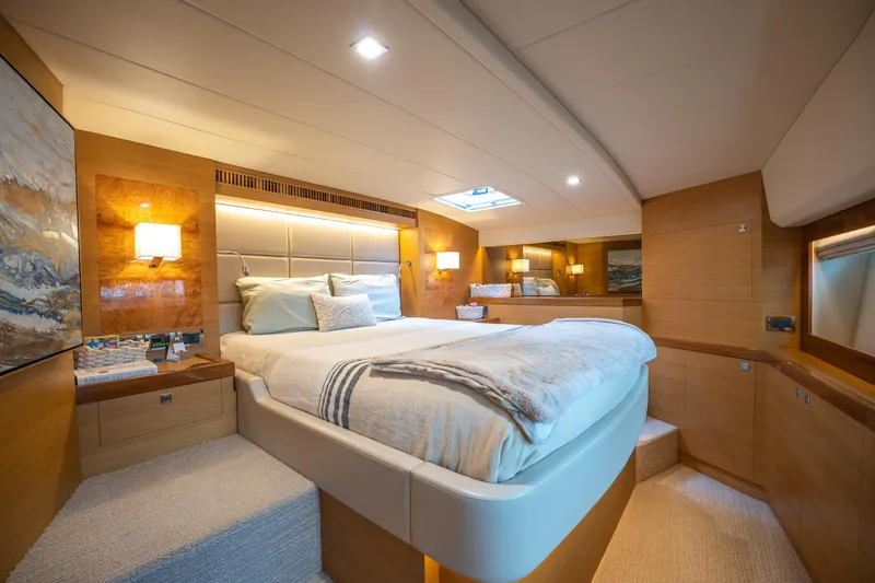 Mystic Soul Yacht Photos Pics Luxurious cabin interior of 2019 Horizon PC52 yacht with elegant bedding and warm lighting.