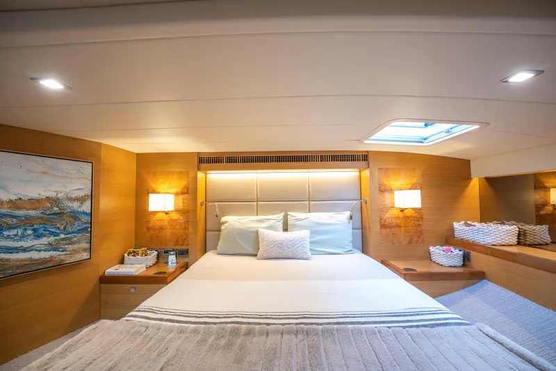 Mystic Soul Yacht Photos Pics Luxurious cabin interior of 2019 Horizon PC52 yacht with modern decor and cozy bedding.
