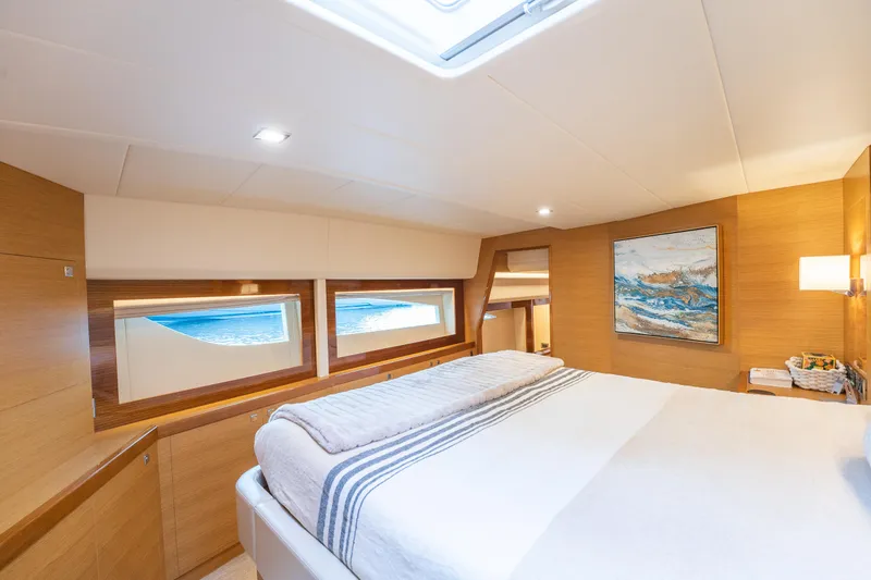 Mystic Soul Yacht Photos Pics Luxurious 2019 Horizon PC52 yacht bedroom with ocean view windows and modern decor.