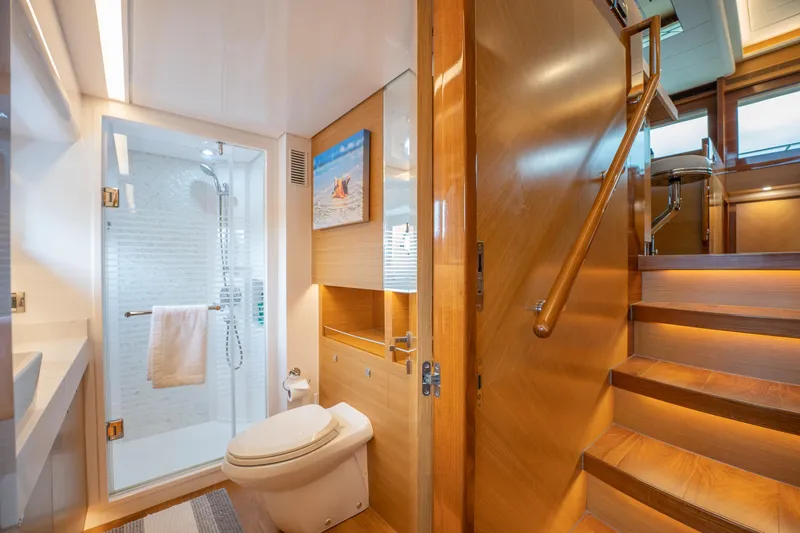 Mystic Soul Yacht Photos Pics Luxurious 2019 Horizon PC52 yacht bathroom with wooden stairs, modern shower, and elegant design.