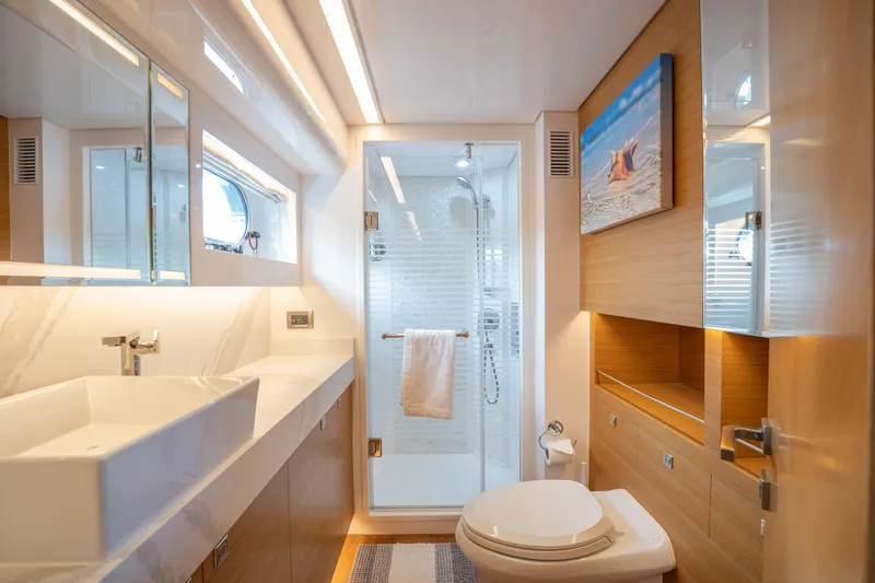 Mystic Soul Yacht Photos Pics Luxurious bathroom in 2019 Horizon PC52 yacht with modern fixtures and glass shower.