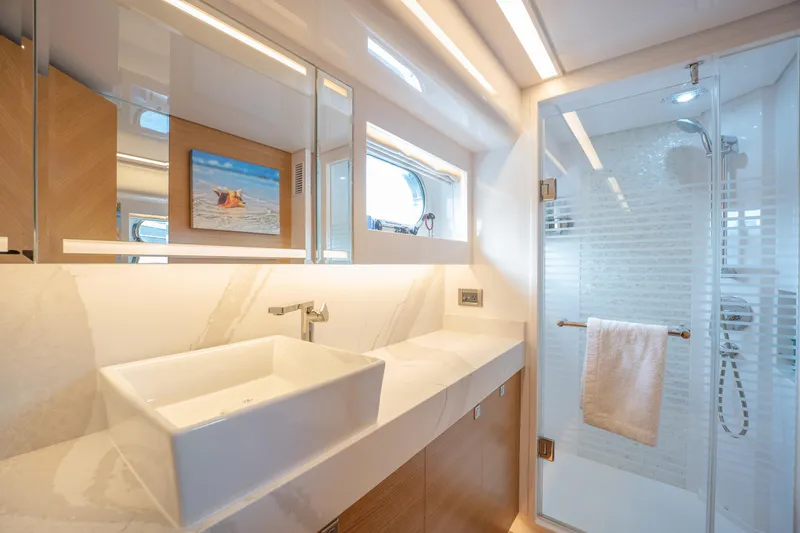 Mystic Soul Yacht Photos Pics Luxurious yacht bathroom with modern sink, glass shower, and elegant lighting, Horizon PC52 2019.