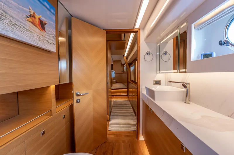 Mystic Soul Yacht Photos Pics Luxurious bathroom interior on 2019 Horizon PC52 yacht, featuring modern fixtures and wooden accents.