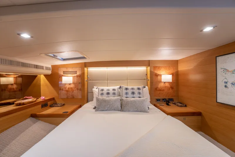 Mystic Soul Yacht Photos Pics Luxurious cabin interior of 2019 Horizon PC52 yacht with elegant bedding and warm lighting.