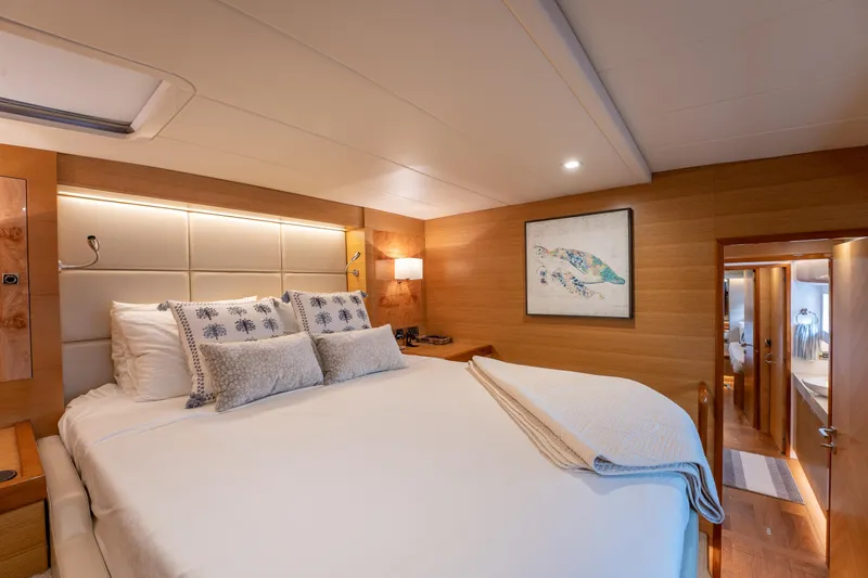 Mystic Soul Yacht Photos Pics Luxurious bedroom interior on 2019 Horizon PC52 yacht, featuring elegant bedding and modern decor.