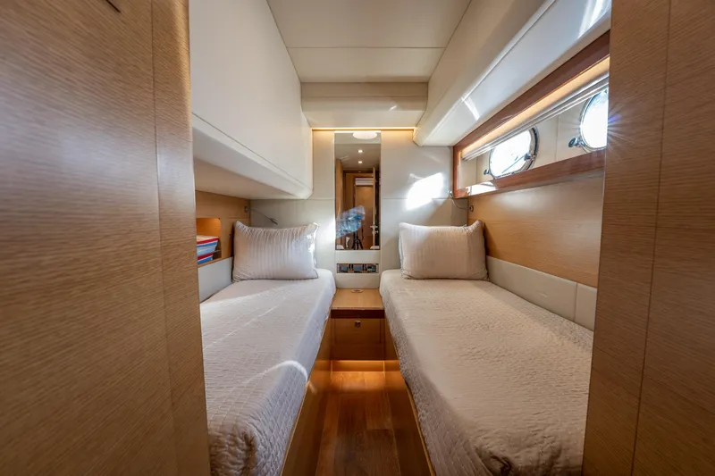 Mystic Soul Yacht Photos Pics Luxurious twin cabin interior on 2019 Horizon PC52 yacht, featuring elegant wood finishes.