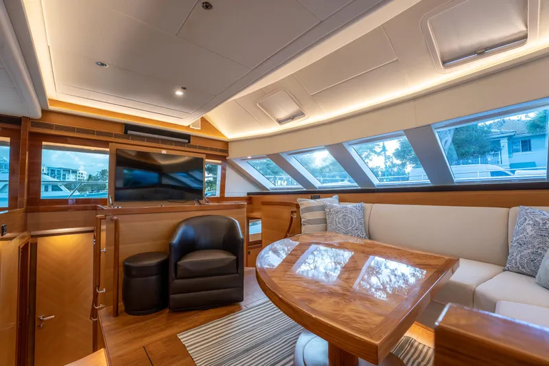 Mystic Soul Yacht Photos Pics Luxurious interior of 2019 Horizon PC52 yacht with plush seating and large windows.