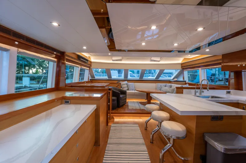 Mystic Soul Yacht Photos Pics Luxurious interior of 2019 Horizon PC52 yacht with modern kitchen and seating area.