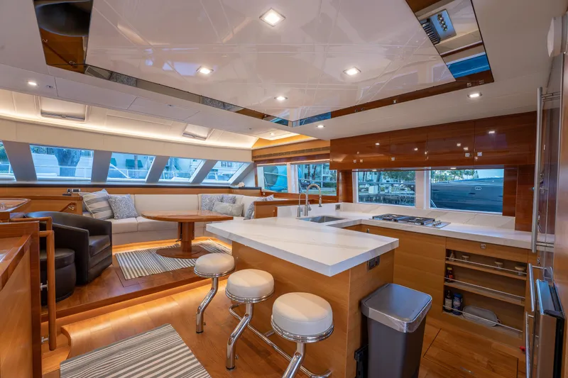 Mystic Soul Yacht Photos Pics Luxurious 2019 Horizon PC52 yacht interior with modern kitchen and seating area.