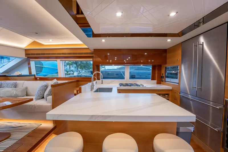 Mystic Soul Yacht Photos Pics Luxurious Horizon PC52 yacht interior with modern kitchen, sleek countertops, and comfortable seating, 2019 model.