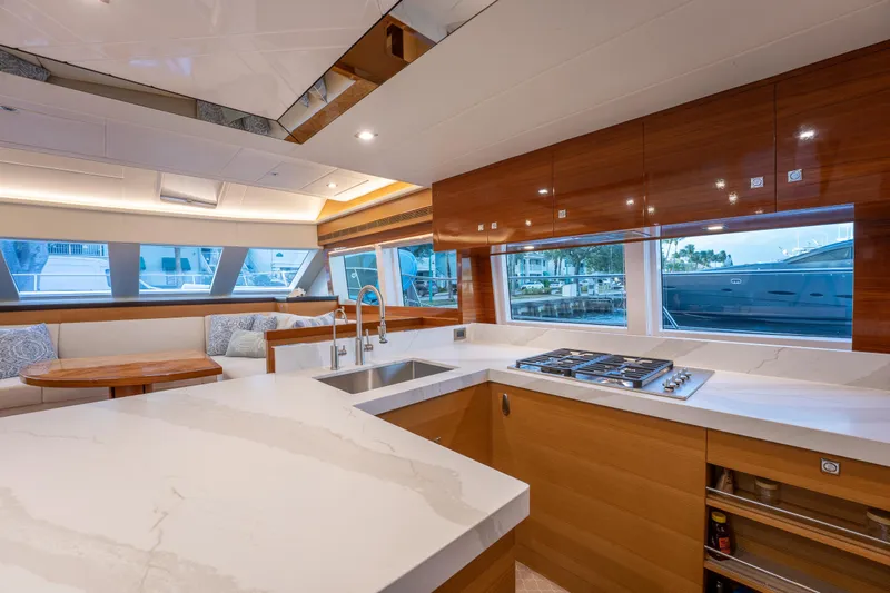 Mystic Soul Yacht Photos Pics Luxurious 2019 Horizon PC52 yacht interior with modern kitchen and dining area.