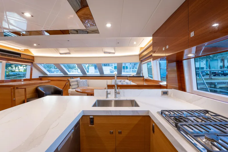 Mystic Soul Yacht Photos Pics Luxurious 2019 Horizon PC52 yacht interior with modern kitchen and spacious seating area.