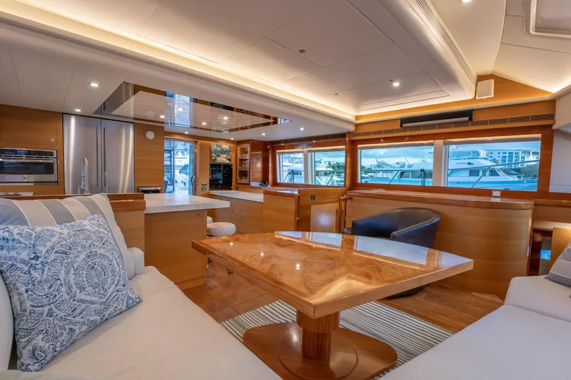 Mystic Soul Yacht Photos Pics Luxurious 2019 Horizon PC52 yacht interior with modern kitchen and elegant seating area.