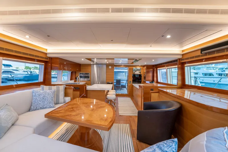 Mystic Soul Yacht Photos Pics Luxurious 2019 Horizon PC52 yacht interior with elegant wood finishes and modern furnishings.
