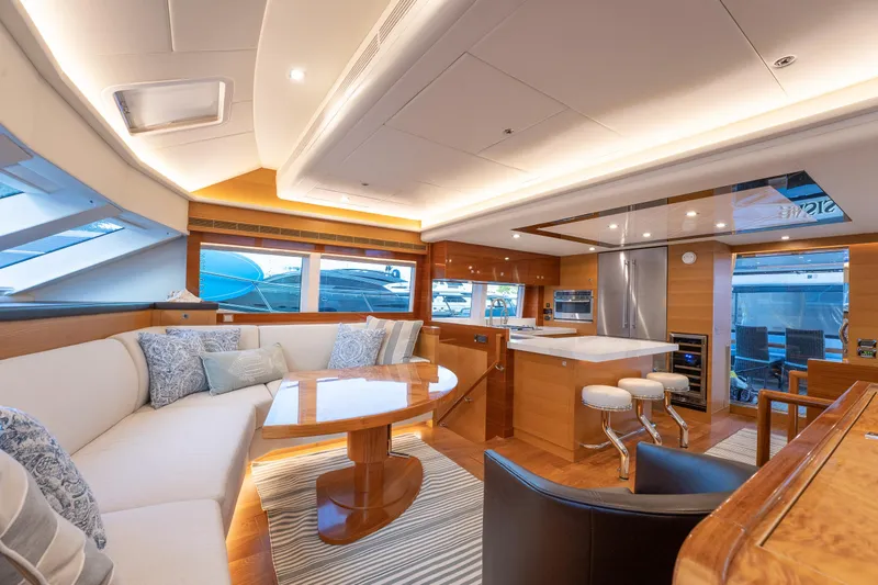 Mystic Soul Yacht Photos Pics Luxurious interior of 2019 Horizon PC52 yacht with modern kitchen and cozy seating area.